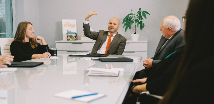 Grant Butson and team sitting in conference room