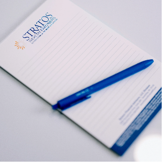 Butson Financial Advisors notepad and blue pen sitting on table