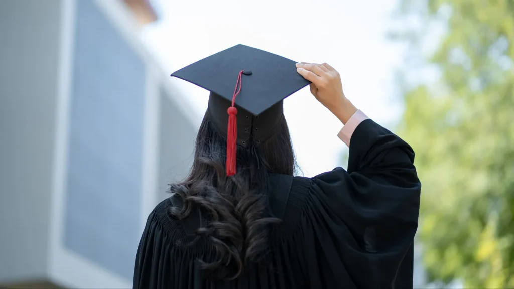 Saving for College with a 529 Plan - Girl wearing her college cap and gown