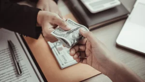 Person handing a financial advisor money