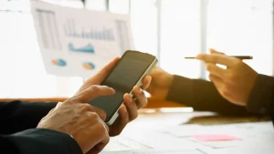 Two people using data and phone calculator