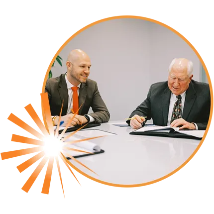 Harry and Grant Butson sitting in conference room to discuss financial futures of clients through personalized financial planning